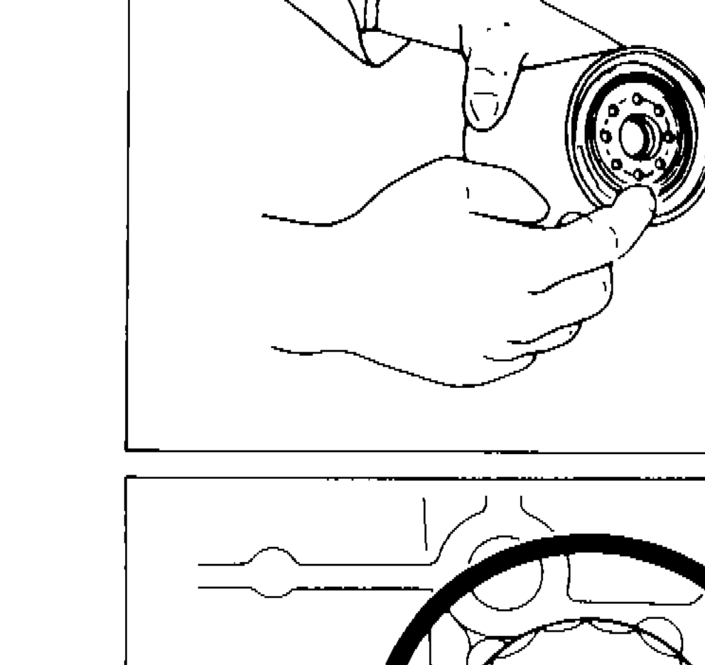 Hands coating rubber seal of oil filter with engine oil before installation