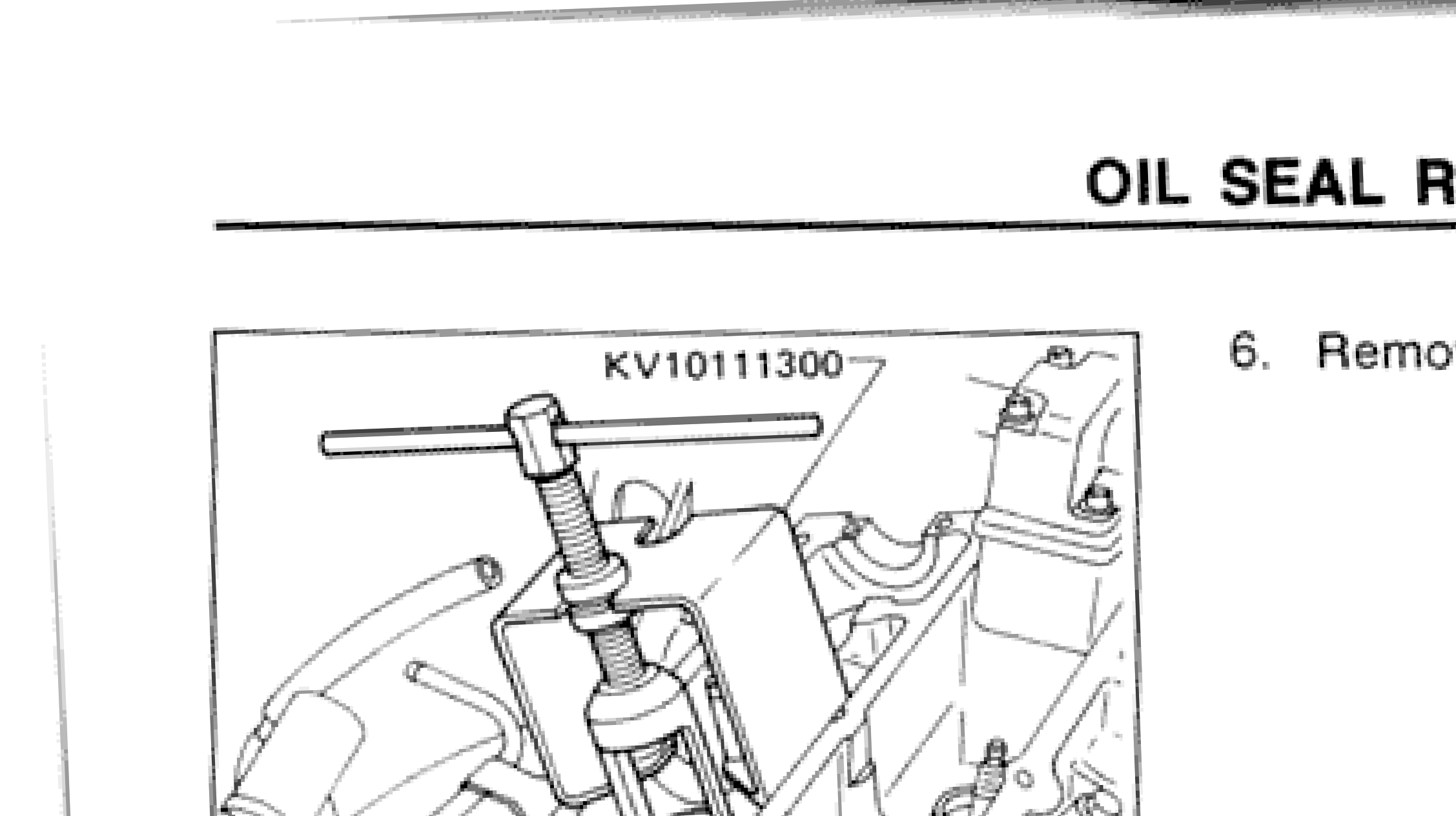 Tool KV10111300 being used to compress valve spring on cylinder head