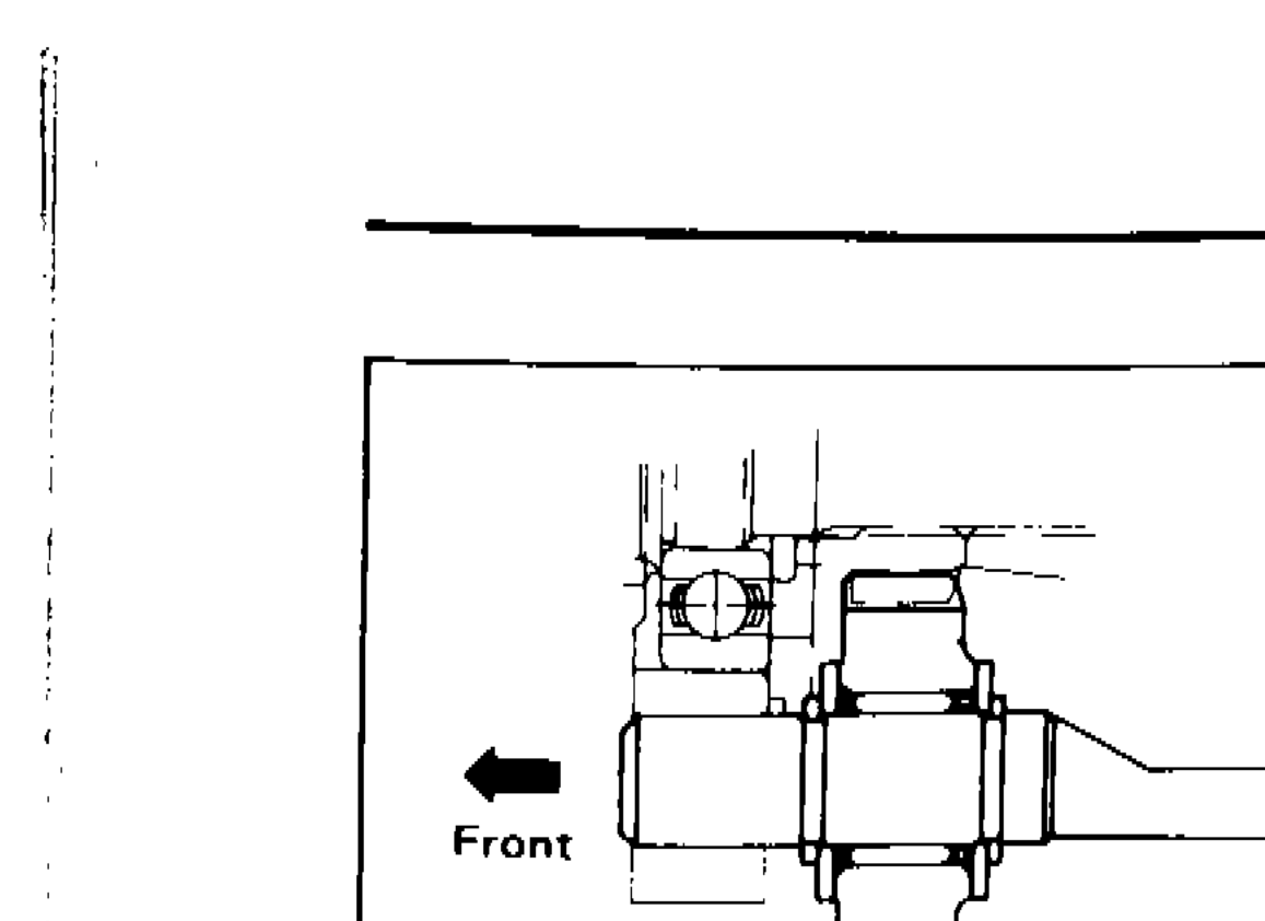 Reverse idler gear installed on reverse idler shaft with spacers, snap rings and needle bearing, arrow indicating front direction