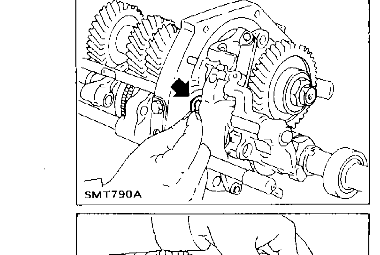 Installing E-ring on O.D. and reverse fork rod, arrow pointing to E-ring location