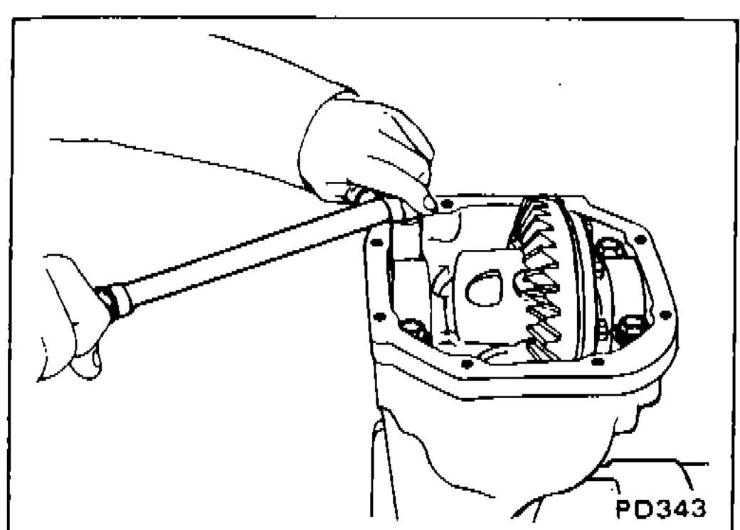 Technician removing side bearing caps from differential carrier using a tool