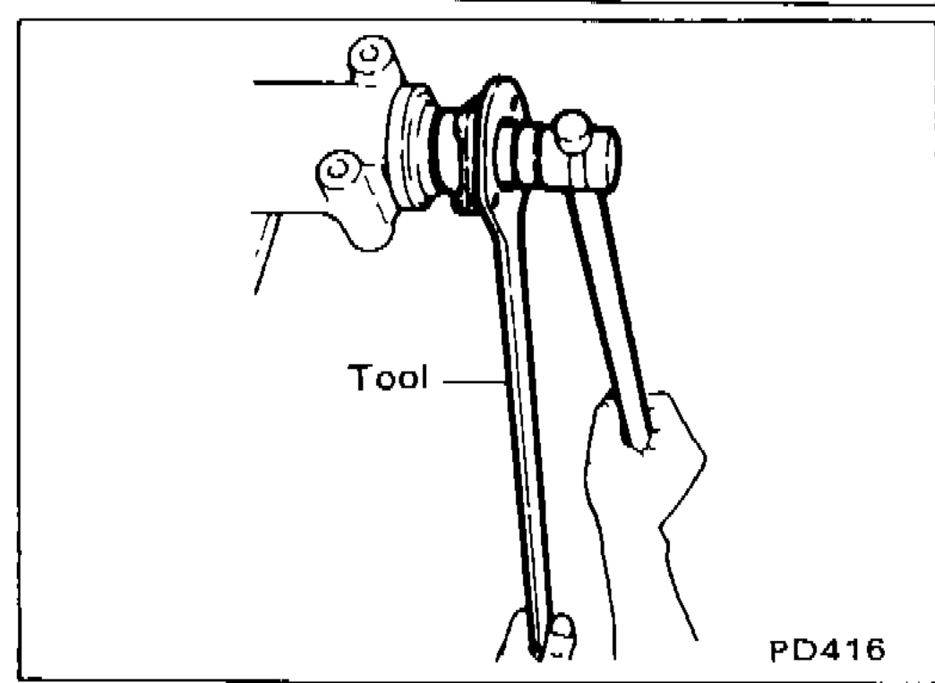 Tool ST38060002 being used to hold companion flange while tightening pinion nut