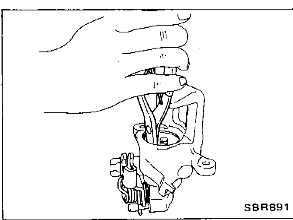 Pliers prying off ring A from the piston to expose the adjusting nut.